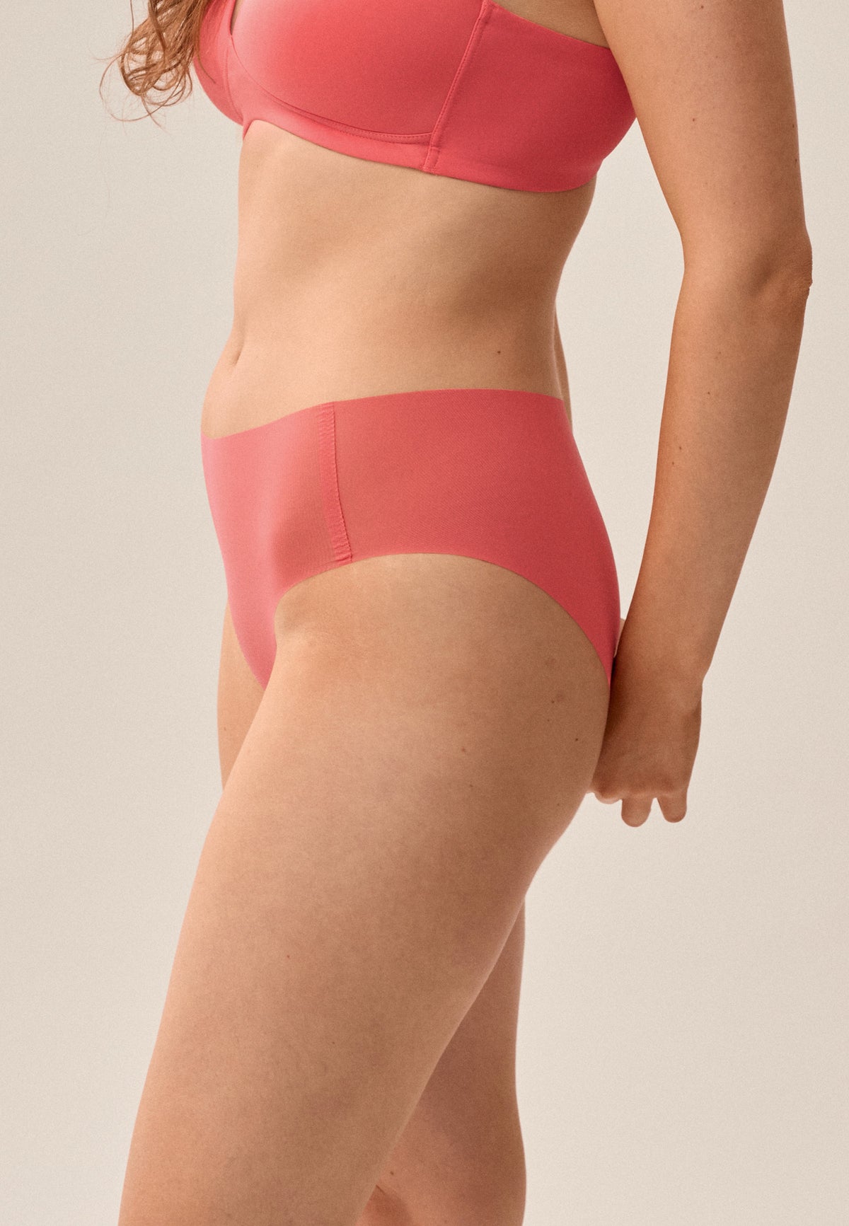 Korallpinke NATURANA One-Size-Panty mit passendem bügellosen Soft-BH, Model von der Seite